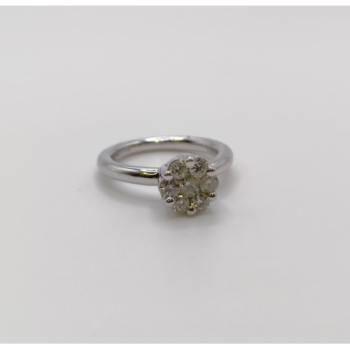 676 - A 9ct white gold and diamond cluster ring, ring size G