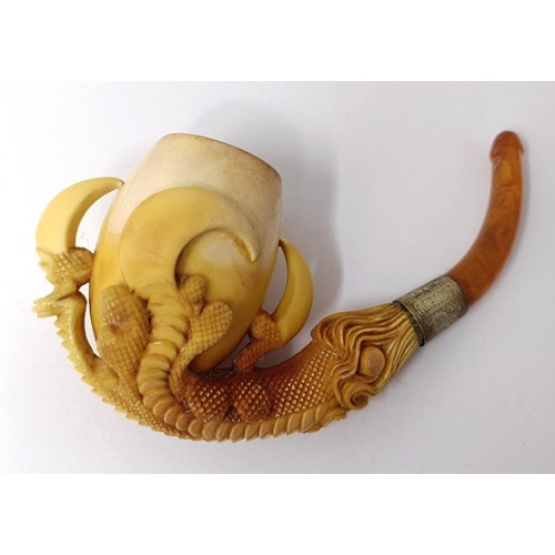 721 - A 19th century meerschaum and amber pipe, in the form of a dragons's claw, in a fitted case