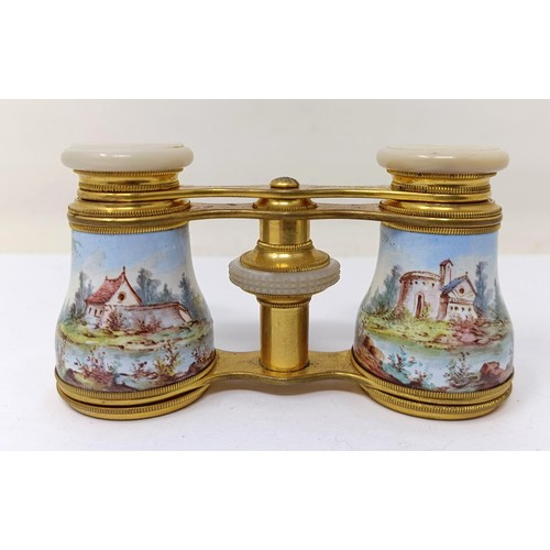 722 - A pair of late 19th/early 20th century French opera glasses, with enamel decoration, decorated figur... 