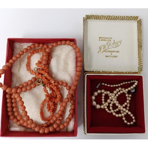 724 - A cultured pearl necklace, and two coral necklaces (3)