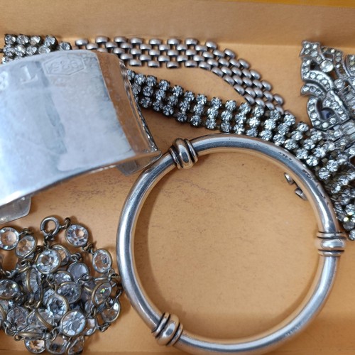 725 - An Art Deco paste set clip brooch, a silver coloured metal bangle, a silver bangle, and two necklace... 