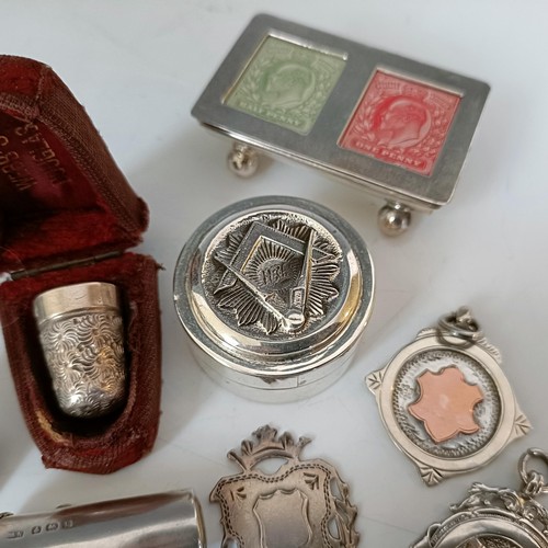 58 - A group of silver medallions, a silver cheroot case, and other items