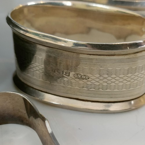 59 - A pair of silver napkin rings, cased, another pair of silver napkin rings, and four pairs of sugar t... 