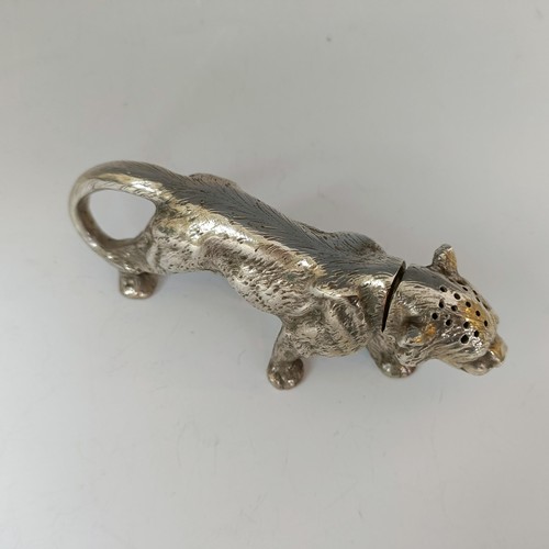 62 - A silver coloured metal pepperette, in the form of a large walking cat, 13.5 cm long