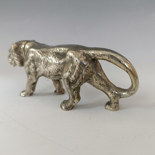 62 - A silver coloured metal pepperette, in the form of a large walking cat, 13.5 cm long