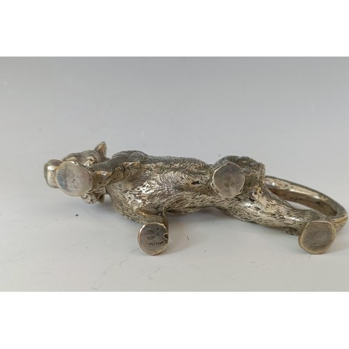 62 - A silver coloured metal pepperette, in the form of a large walking cat, 13.5 cm long