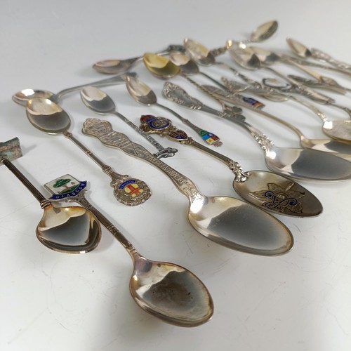 74 - Assorted silver coloured metal and other travel/commemorative spoons, some with enamel decoration