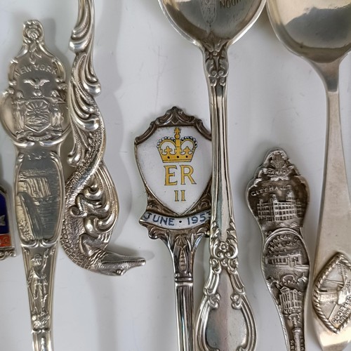 74 - Assorted silver coloured metal and other travel/commemorative spoons, some with enamel decoration