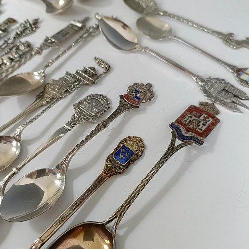 75 - Assorted silver coloured metal and other travel/commemorative spoons, some with enamel decoration