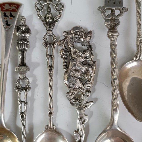 75 - Assorted silver coloured metal and other travel/commemorative spoons, some with enamel decoration