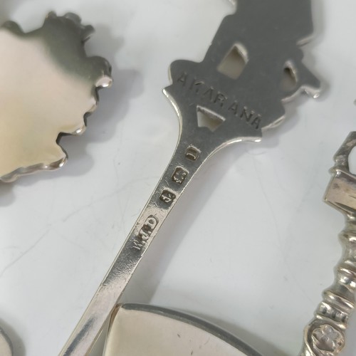 75 - Assorted silver coloured metal and other travel/commemorative spoons, some with enamel decoration