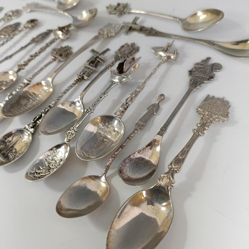 76 - A group of silver and silver coloured metal souvenir spoons