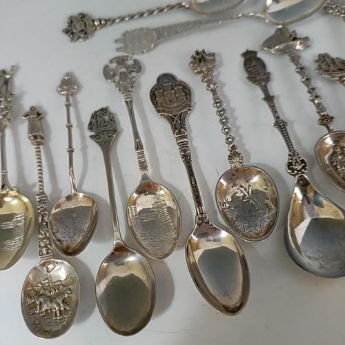 76 - A group of silver and silver coloured metal souvenir spoons