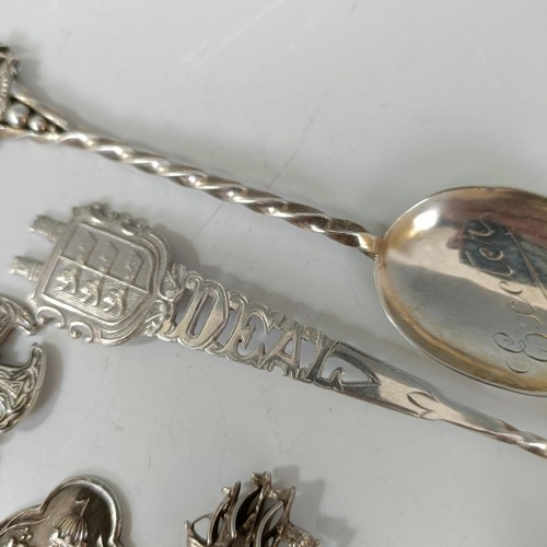 76 - A group of silver and silver coloured metal souvenir spoons