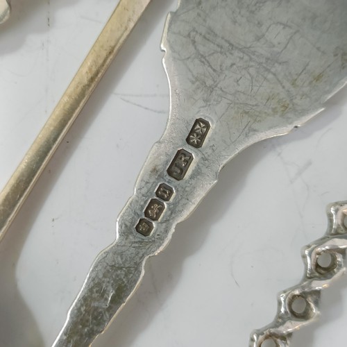 76 - A group of silver and silver coloured metal souvenir spoons