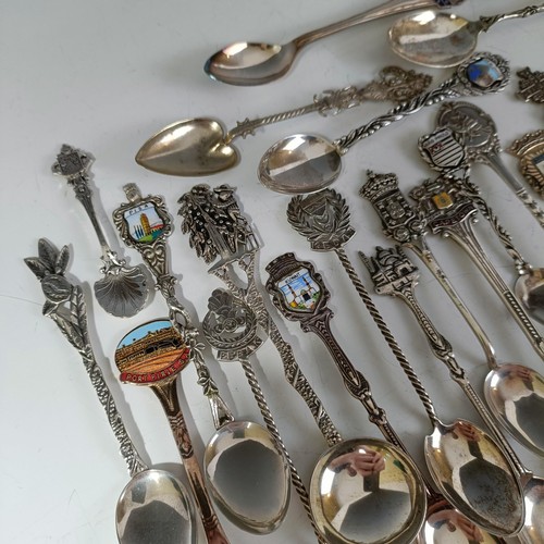 77 - Assorted silver coloured metal and other travel/commemorative spoons, some with enamel decoration