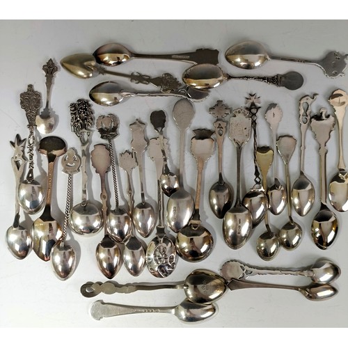 77 - Assorted silver coloured metal and other travel/commemorative spoons, some with enamel decoration