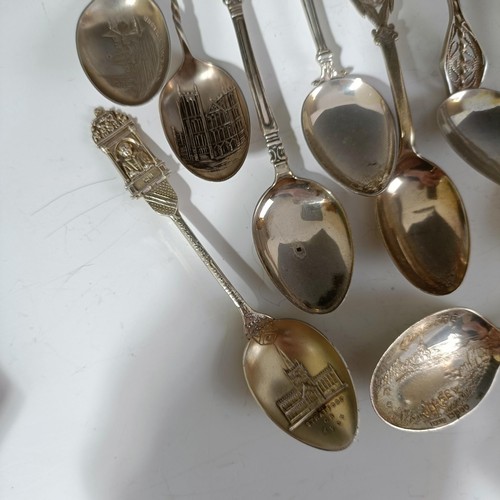 78 - Assorted silver coloured metal and other travel/commemorative spoons, some with enamel decoration