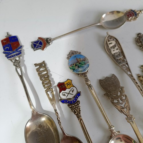 78 - Assorted silver coloured metal and other travel/commemorative spoons, some with enamel decoration