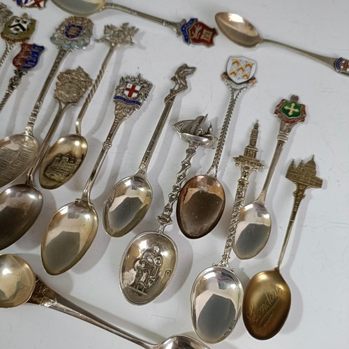 80 - Assorted silver coloured metal and other travel/commemorative spoons, some with enamel decoration