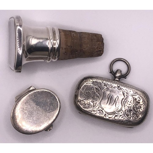 288 - A George V silver sovereign holder, a silver mounted wine stopper, and an oval box