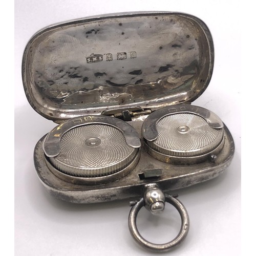 288 - A George V silver sovereign holder, a silver mounted wine stopper, and an oval box