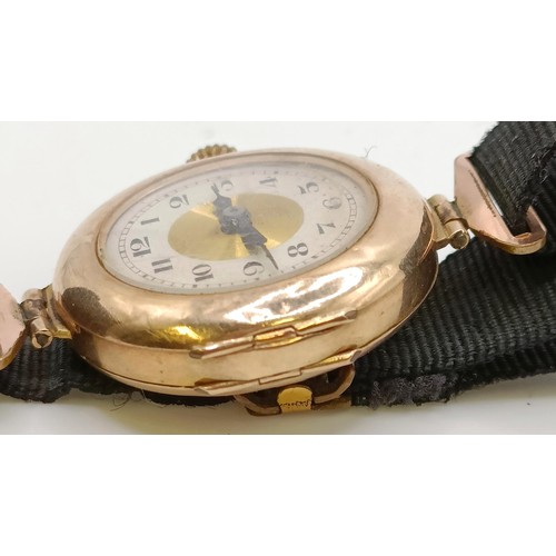 768 - A ladies 9ct gold wristwatch, on a silk strap