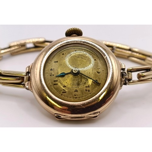 776 - A ladies 9ct gold wristwatch, with a Rolex movement, on a gold plated expandable strap