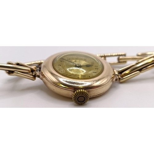 776 - A ladies 9ct gold wristwatch, with a Rolex movement, on a gold plated expandable strap