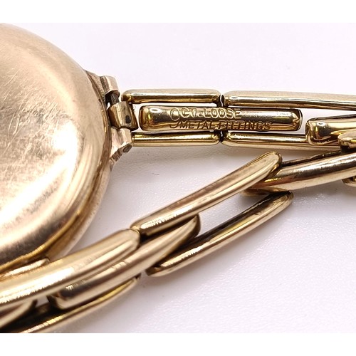 776 - A ladies 9ct gold wristwatch, with a Rolex movement, on a gold plated expandable strap