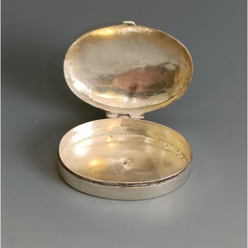 306 - An oval silver pill box, with engraved decoration