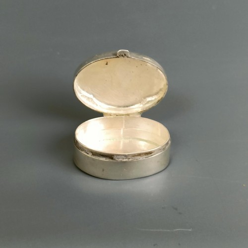 307 - A small oval silver pill box