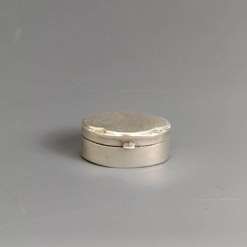 318 - A small oval silver pill box