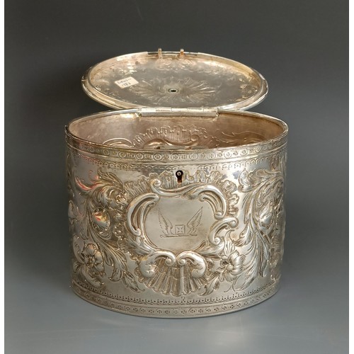 329 - A late 18th century oval silver tea caddy, crested, and embossed scrolling foliage, London 1783, 12.... 