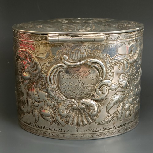 329 - A late 18th century oval silver tea caddy, crested, and embossed scrolling foliage, London 1783, 12.... 