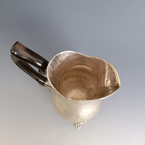 330 - An 18th century style Continental silver coloured metal jug, on three pad feet, 13 cm high