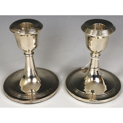 186 - A pair of silver dressing table candlesticks, Birmingham 1944, 11.5 cm high, a pair of silver salts,... 