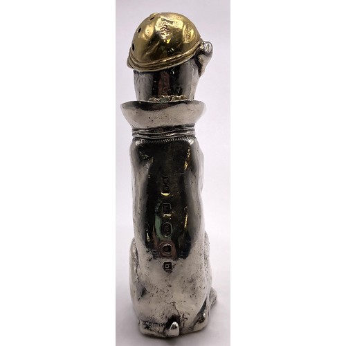 161 - A modern silver and silver gilt pepperette, in the form of a seated dog, wearing a cap, London 2001,... 