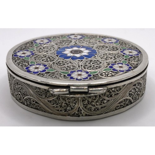 138 - A silver coloured metal filigree and enamel box, 5 cm diameter