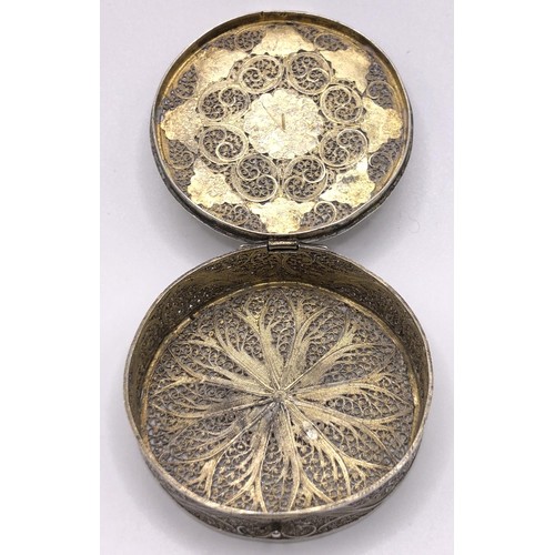 138 - A silver coloured metal filigree and enamel box, 5 cm diameter