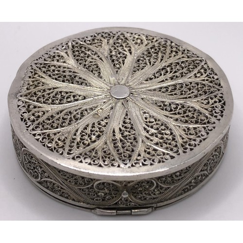 138 - A silver coloured metal filigree and enamel box, 5 cm diameter