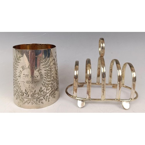 37 - A late Victorian silver christening mug, inscribed and dated 1899, and a silver toast rack, 5.5 ozt ... 