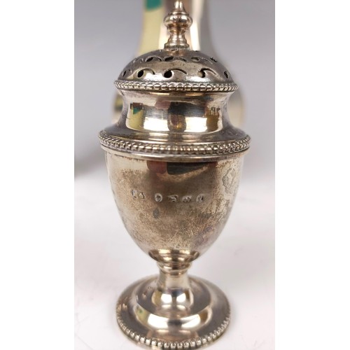 35 - A silver sugar caster, Sheffield 1923, a silver pepperette, 4.7 ozt, and a silver mounted peppermill... 