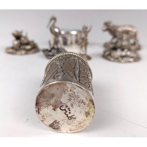 42 - A silver pill box, the top decorated a swan, a silver coloured metal pepperette, and other items