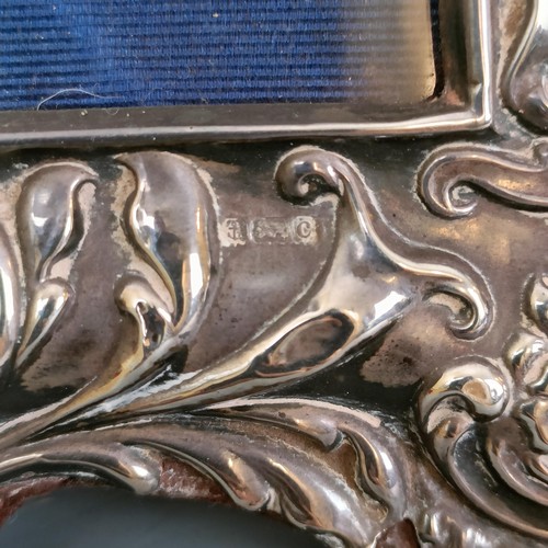 380 - An Edward VII silver mounted strut photograph frame, with embossed decoration, Birmingham 1902, 17 c... 