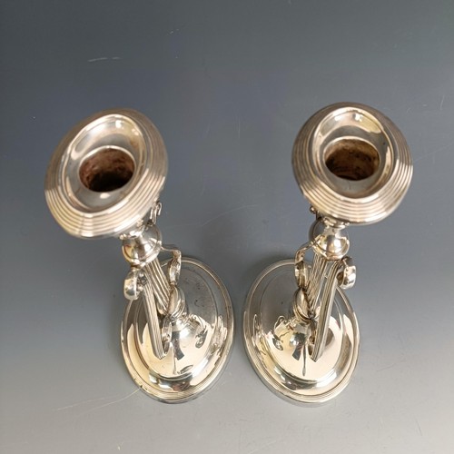 386 - A pair of silver candlesticks, of lyre form, marks rubbed, probably London 1929, 20.5 cm high