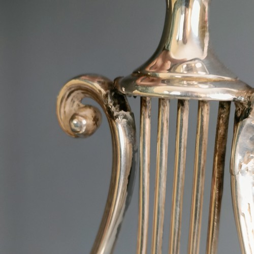 386 - A pair of silver candlesticks, of lyre form, marks rubbed, probably London 1929, 20.5 cm high