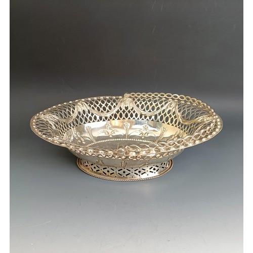 387 - A late 18th century oval silver swing handled basket, with pierced and embossed decoration, London 1... 