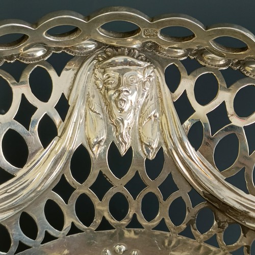 387 - A late 18th century oval silver swing handled basket, with pierced and embossed decoration, London 1... 