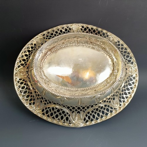 387 - A late 18th century oval silver swing handled basket, with pierced and embossed decoration, London 1... 